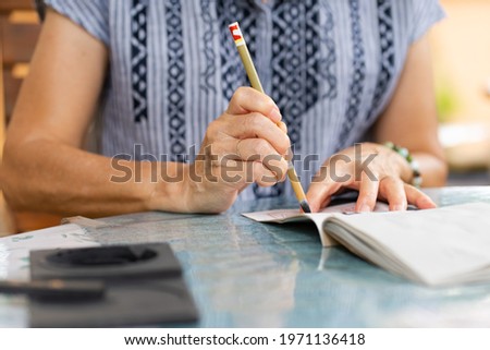 close up hands of senior woman practices eriting calligraphy of traditional chinese characters Stok fotoğraf © 