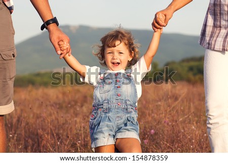 Happy mother and father with daugther