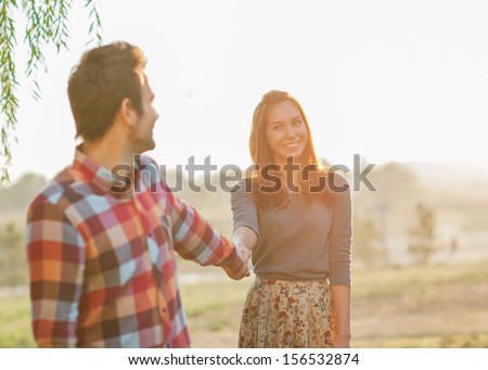 Couple Holding Hands Walking Away, smiling