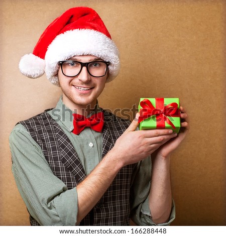Guy holding a gift and emotionally happy Christmas