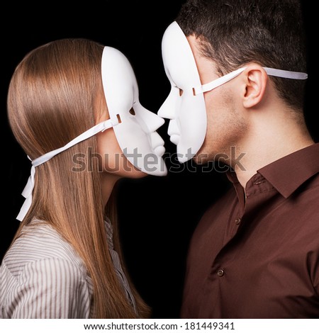 Fashion Happy Couple in Love holding with mask face. Psychological concept. Duality look at relationships.