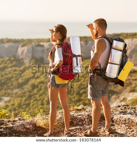 Hikers - people hiking, man looking at mountain nature landscape scenic with woman in background.