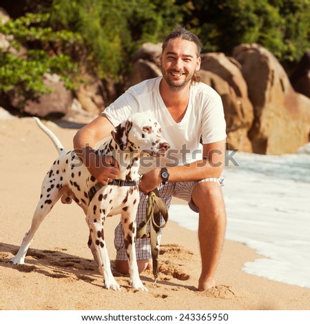man with dog on the tropical beach