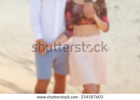 Young couple in love walking in the  park holding hands looking in the sunset, blurry photos -Concept