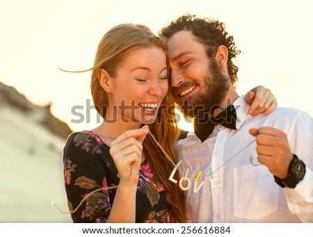 happy couple in love on the sand dunes, concept of Valentine\'s Day