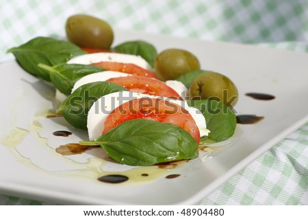 caprese salad with pepper, olive oil and aceto balsamico