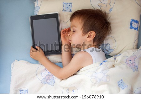 Boy, sleeping with tablet