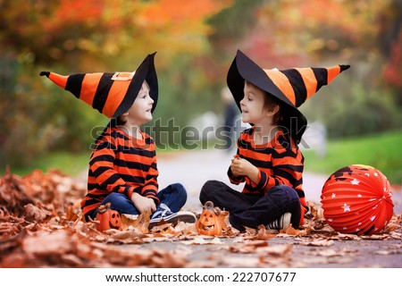 Two boys in the park with Halloween costumes, having fun