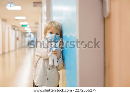 Similar – Image, Stock Photo Sad boy in medical mask near window