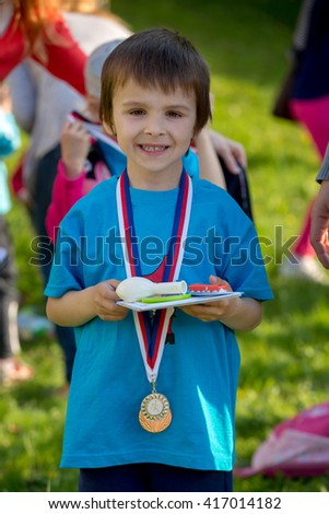 proud preschool boy holding prizes and medals after annual sport kinder garden competition 417014182 - Kinder Kid Competition proud preschool boy holding prizes and medals after annual sport kinder garden competition 417014182 - Kinder Kid Competition