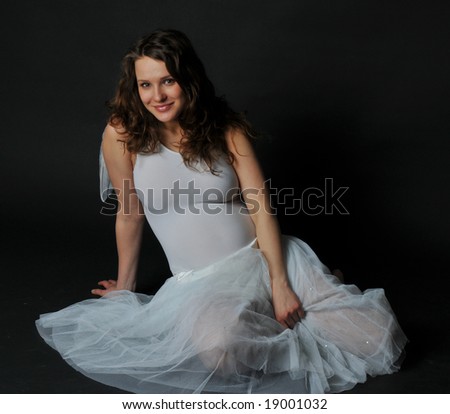 Pregnant woman on a black background with angel wings