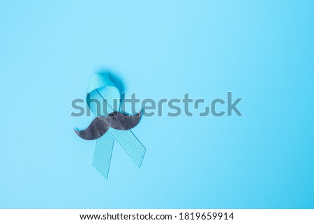 November Prostate Cancer Awareness month, light Blue Ribbon with mustache for supporting people living and illness. Healthcare, International men, Father and World cancer day concept 商業照片 © 