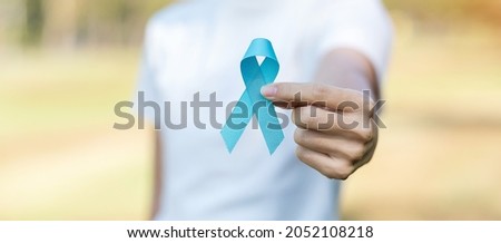 November Prostate Cancer Awareness month, woman holding Blue Ribbon for supporting people living and illness. Healthcare, International men, Father, World cancer day and world diabetes day concept 商業照片 © 