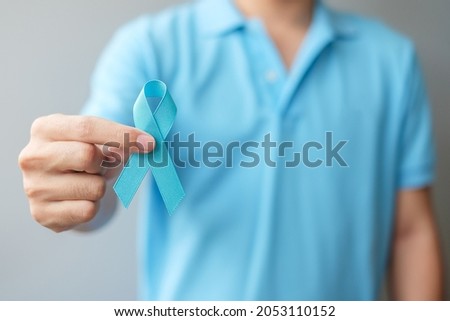 November Prostate Cancer Awareness month, Man in blue shirt with hand holding Blue Ribbon for supporting people living and illness. Healthcare, International men, Father and World cancer day concept Сток-фото © 