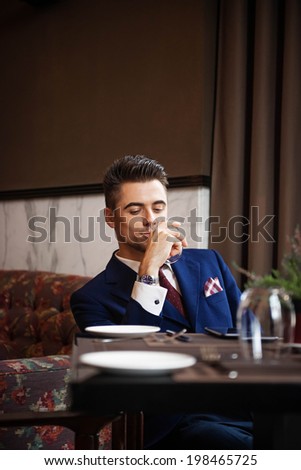 Successful businessman sitting at the table of the restaurant