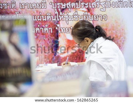 Bangkok, Thailand - October 18, 2013 : Tomyuntee signing a book at the books fair on October 18, 2013 in Bangkok, Thailand
