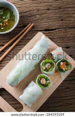 Fresh Spring Rolls with vegetables and pork on old wooden table