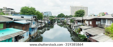 Poor house And the dirty water canal in suburb Thailand. panorama