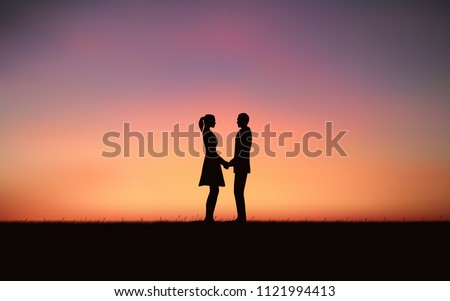 Silhouette couple holding hand and standing together on hill under sunset sky background