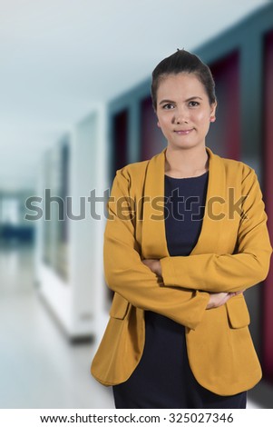 Business woman standing isolated grey wall background. Beautiful mixed race Thailand Asian-Caucasian young female mode in suit.