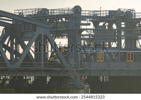 Similar – Foto Bild Gegenlichtlandschaftsbild mit Brücke, Fluss und Strommast