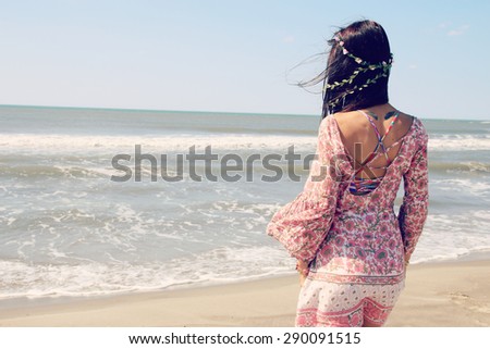 beautiful woman facing the sea