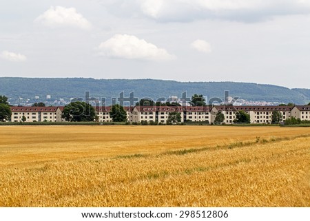 North-West  view of the empty houses of former U.S. military camp Patrick Henry Village near Heidelberg, Germany,  from the empty harvested grain fields on the Odenwald forest background