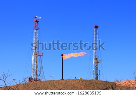 Similar – Image, Stock Photo Gas flaring at oil refinery in evening