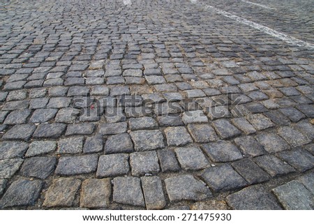 Grey cobblestone road.\
Warsaw, Poland, Old Town.