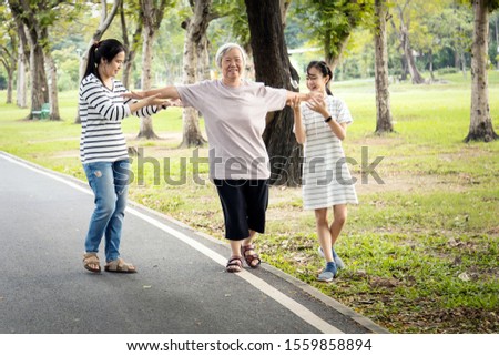 Similar – Image, Stock Photo Woman walking and balancing on a wooden railing at the coast line.