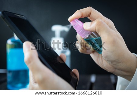 Similar – Image, Stock Photo Woman disinfecting phone with antiseptic wet wipe. Antiseptic napkin to prevent spread of germs, bacteria and coronavirus. Coronavirus prevention. Prevent illness coronavirus after public place.