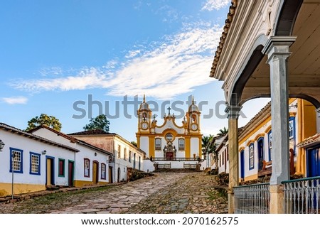 A quiet historic street in the city of Tiradentes in Minas Gerais with colonial houses and a baroque church in the background Stockfoto © 