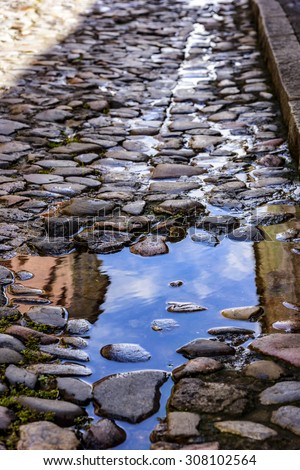 Water puddle in the ancient cobbled hills in Pelourinho in Salvador