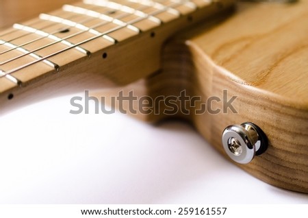Section of an electric guitar where a guitar strap would be attached.