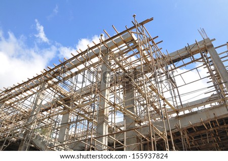 Construction site with scaffolding against blue clear sky