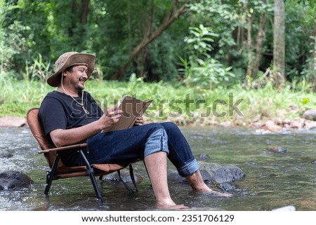 Similar – Image, Stock Photo Relaxed man reading notes in notebook