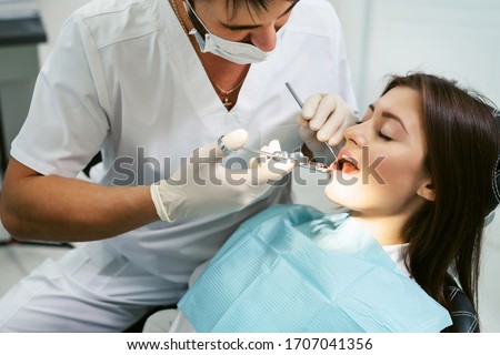 Similar – Image, Stock Photo Crop dentist examining teeth of patient in clinic