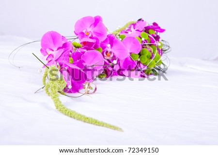 Wedding rings and a violet bouquet - studio photo