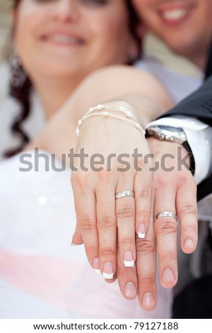 Happy newly married couple showing off their new wedding rings
