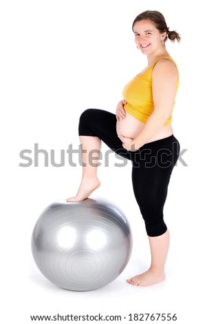 A pregnant woman doing a breathing exercise with an exercise ball