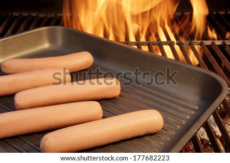 Sausages put on the grill pan and background of flames. You can see more flames, fire and barbecue on my page. Good luck in your art work!