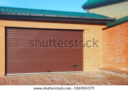 Automatic Garage Rolling Gate with tilt shift effect on the top and right side of the image.