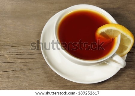 Tea Cup on the rough wooden table or floor, with space for text or image