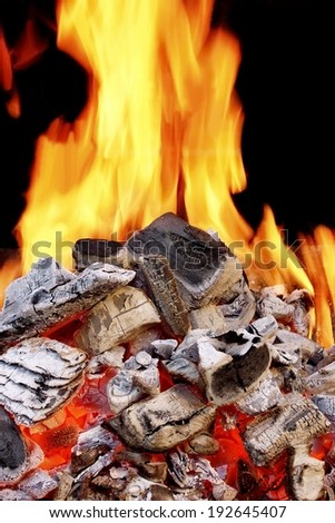 Burning Charcoal in BBQ close-up and Flames in background. You can see more BBQ, Grilled food, flames and fire on my page.