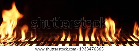 Barbecue Fire Grill Isolated On Black Background. BBQ Flaming Charcoal Grill Isolated. Hot Barbeque Charcoal Cast Iron Grill With Bright Flames Of Fire. Abstract Panoramic Grill Wide Banner.
