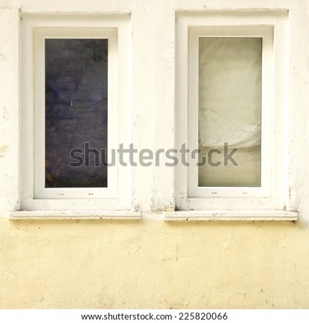 Two Old Closed Windows  in the Old White Concrete Wall. Background and Texture for text or image