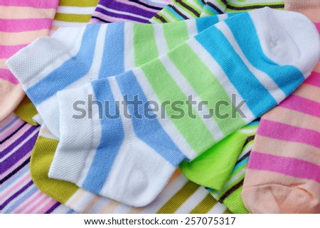 Stack Of Many Pairs of Colorful Striped Socks isolated On White Background