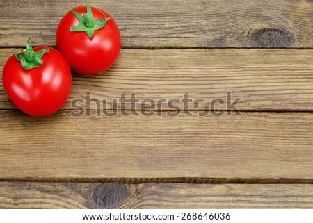 Two Ripe Shinny Fresh Tomatoes On Rough Rustic Wood Tabletop