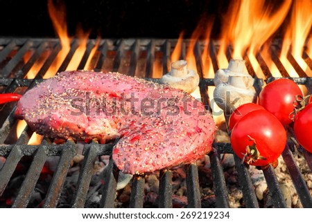 Raw Fresh Bloody Strip Steak, Tomatoes And Mushrooms On Hot Grill. Flames Of Fire On The Background