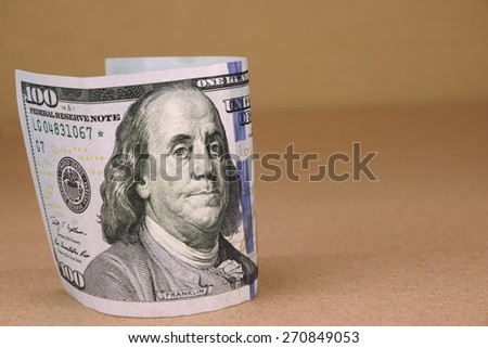 New One Hundred USA Dollar Bill On The Rough Paper Background